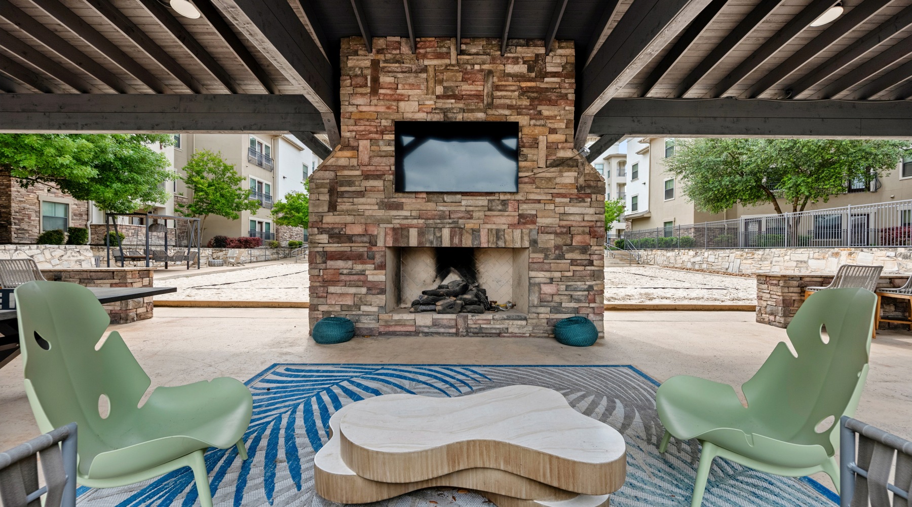 an outdoor lounge area with grills