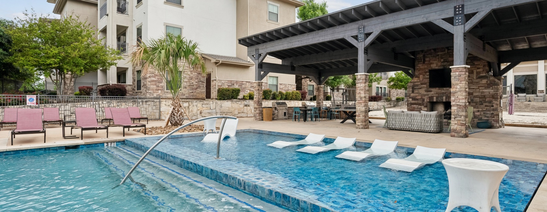 a large sparkling pool with lounge chairs