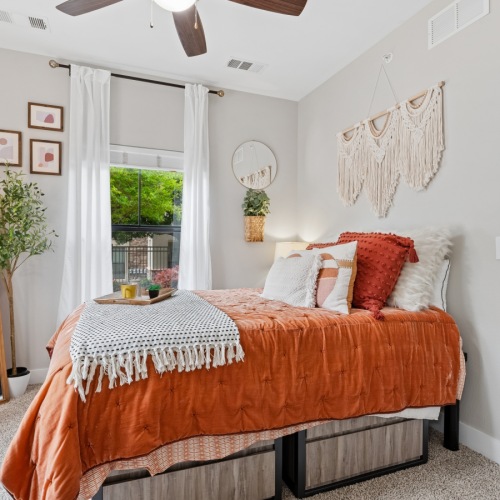 a bedroom with a bed, desk and chair