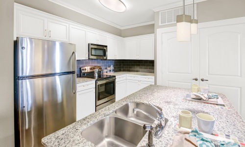 a kitchen with white cabinets